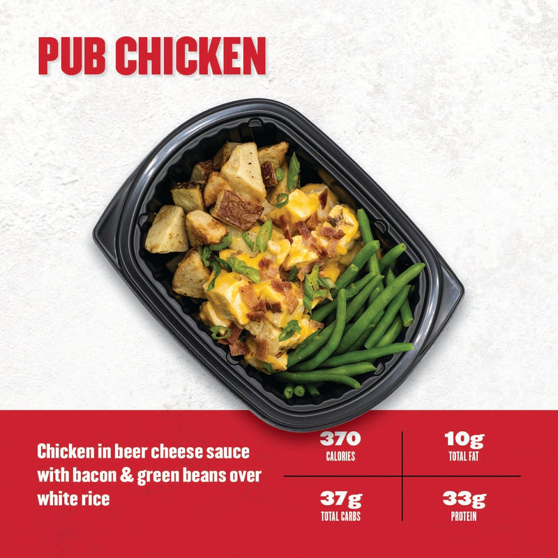 Pub Chicken – roasted chicken in beer cheese sauce with crispy potatoes, bacon, and green beans over white rice in a black meal prep tray from Clean Eatz Kitchen.