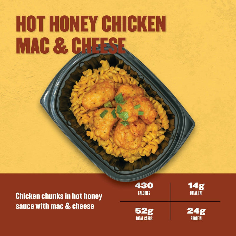 Hot Honey Chicken Mac & Cheese – crispy chicken chunks coated in hot honey sauce served over creamy rotini mac and cheese in a black meal prep tray.