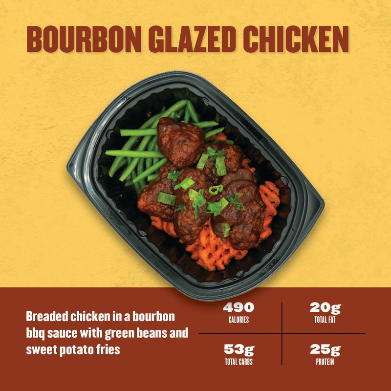 Bourbon Glazed Chicken – breaded chicken tossed in bourbon BBQ sauce, served with sweet potato fries and green beans in a black container.