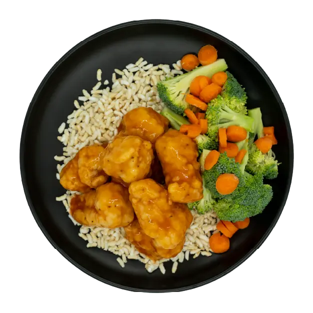 Sweet and sour chicken with broccoli, carrots, and brown rice on a black plate.