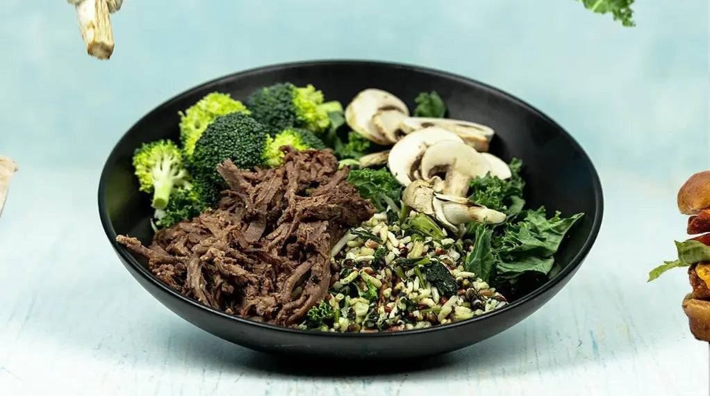 Clean protein bowl with shredded beef, broccoli, mushrooms, and grain blend