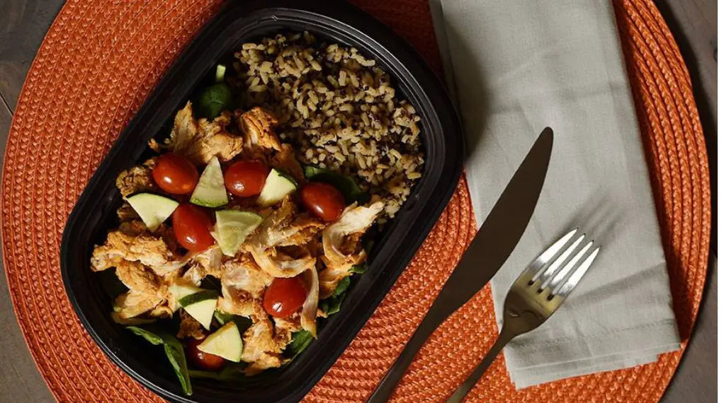 Protein-boosted meal with grilled chicken, rice, tomatoes, and avocado