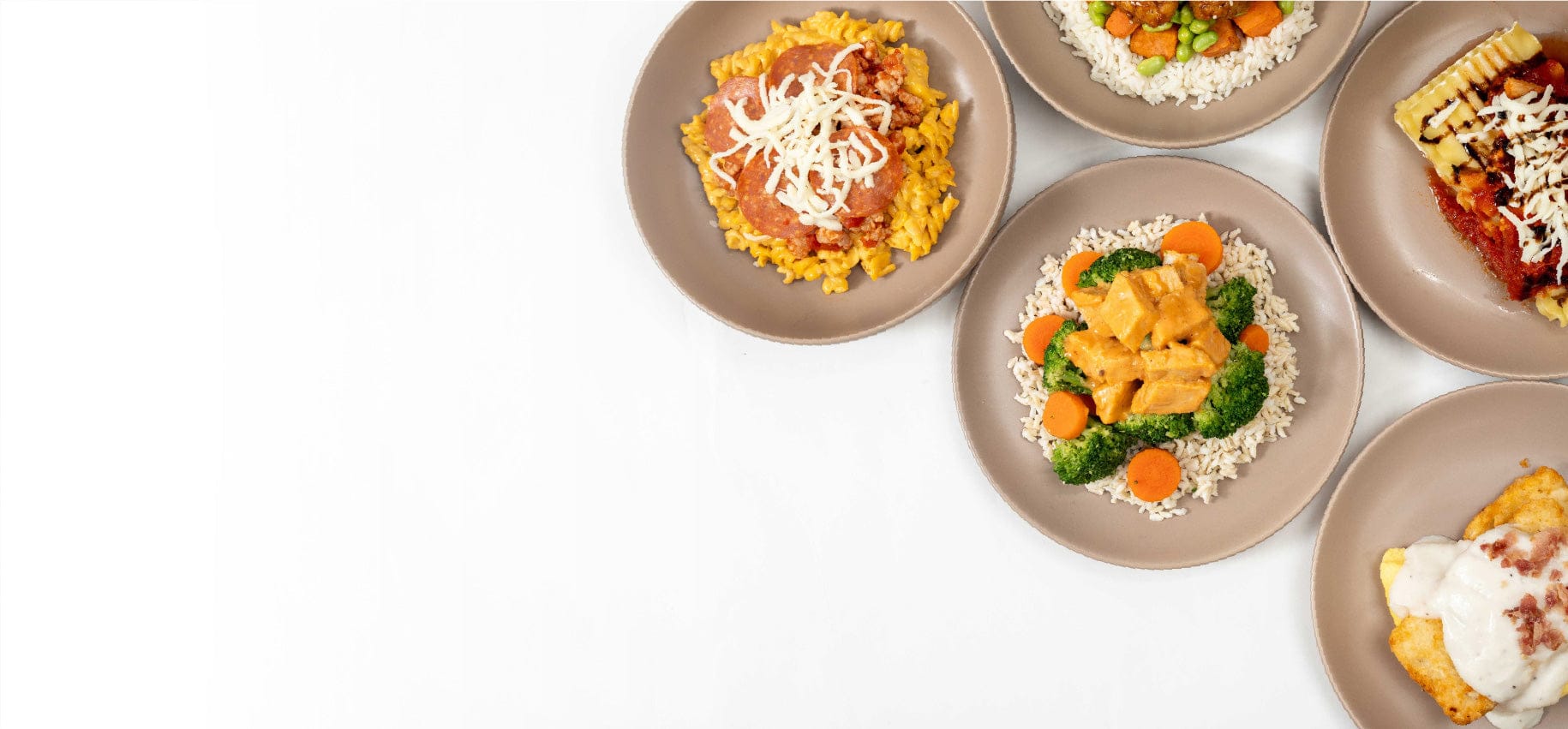 Plates of food arranged in a row on a white background