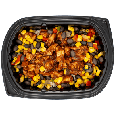 Diced chicken in a sweet chili-style sauce with corn, black beans, and peppers over rice in a black meal tray.