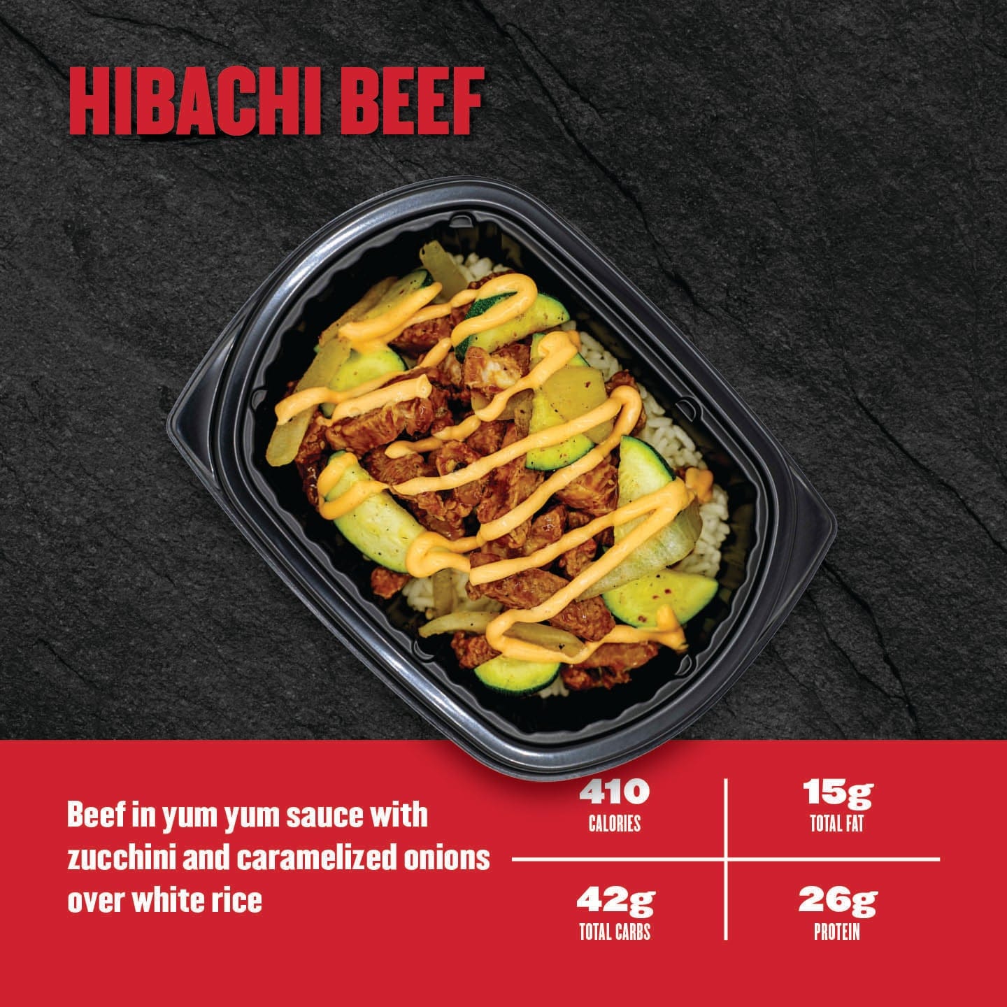 Hibachi beef dish with zucchini and caramelized onions over white rice, served in a black container on a dark background.