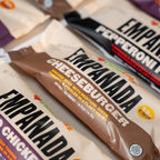 Empanada packages in various flavors on a neutral background