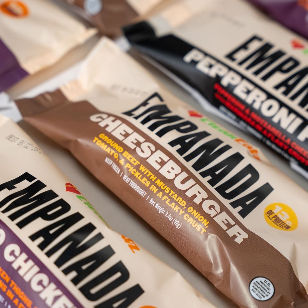 Empanada packages in various flavors on a neutral background