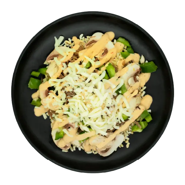 Shredded beef with peppers, onions, mozzarella, and creamy sauce over brown rice on a black plate.