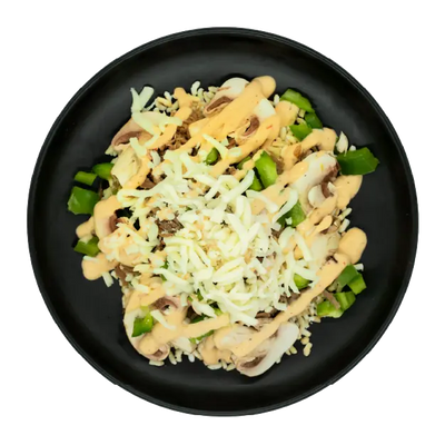 Shredded beef with peppers, onions, mozzarella, and creamy sauce over brown rice on a black plate.