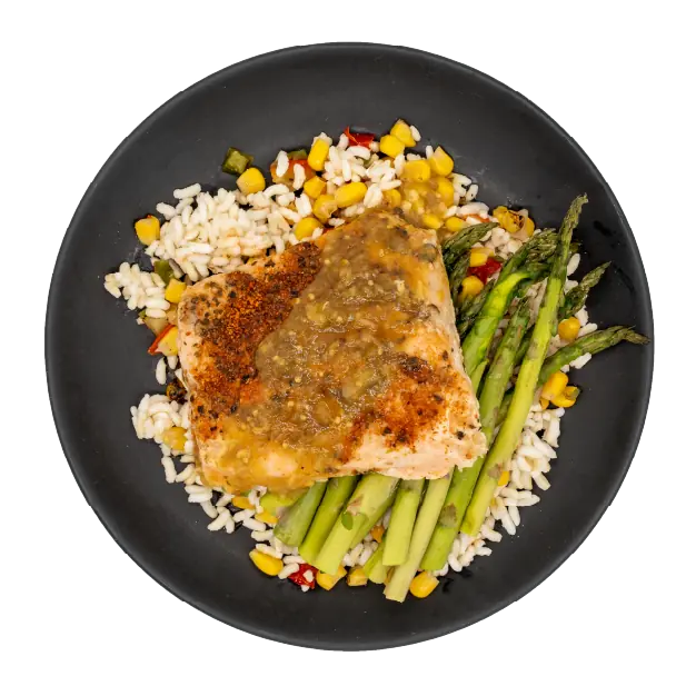 Salmon with asparagus over rice, corn, and peppers on a black plate.