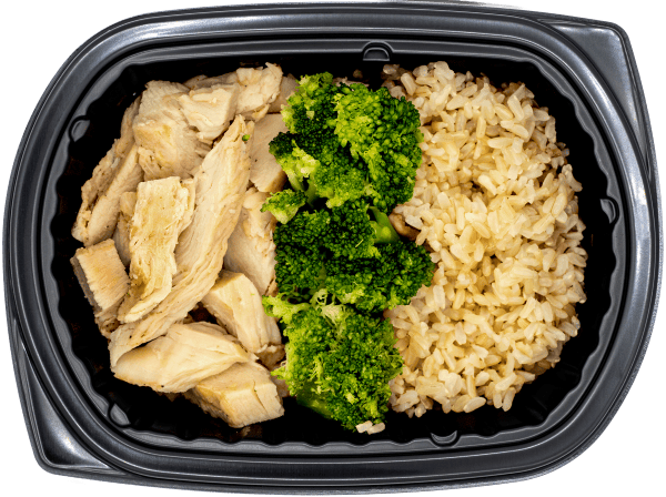 Diced chicken with broccoli over brown rice in a black meal tray.