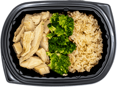 Diced chicken with broccoli over brown rice in a black meal tray.