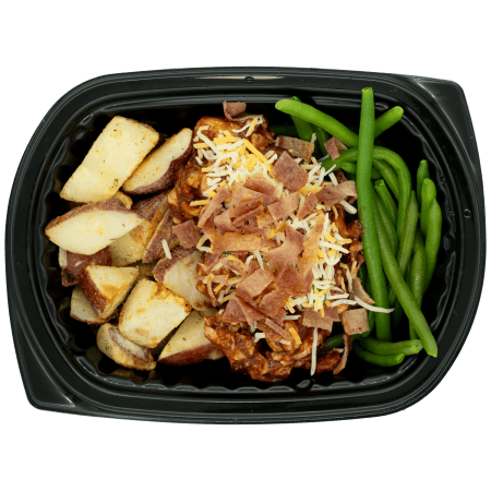 BBQ chicken topped with shredded cheese and bacon, served with roasted red potatoes and green beans in a black meal tray.