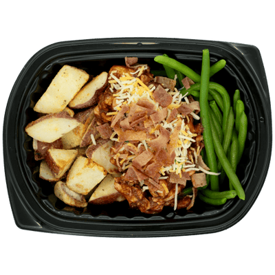 BBQ chicken topped with shredded cheese and bacon, served with roasted red potatoes and green beans in a black meal tray.
