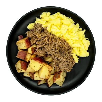 Shredded beef with scrambled eggs and roasted red potatoes on a black plate.