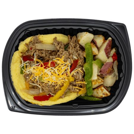 Steak omelette in a black meal tray with shredded cheese, sautéed peppers and onions, and a side of seasoned breakfast potatoes.