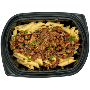 Chopped brisket over mac and cheese with penne pasta in a black meal tray.
