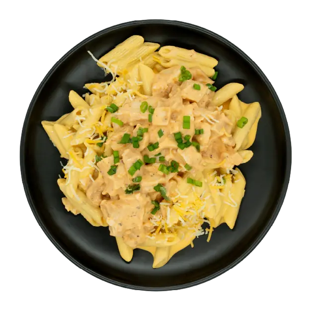 Buffalo chicken mac and cheese topped with shredded cheese and green onions on a black plate.