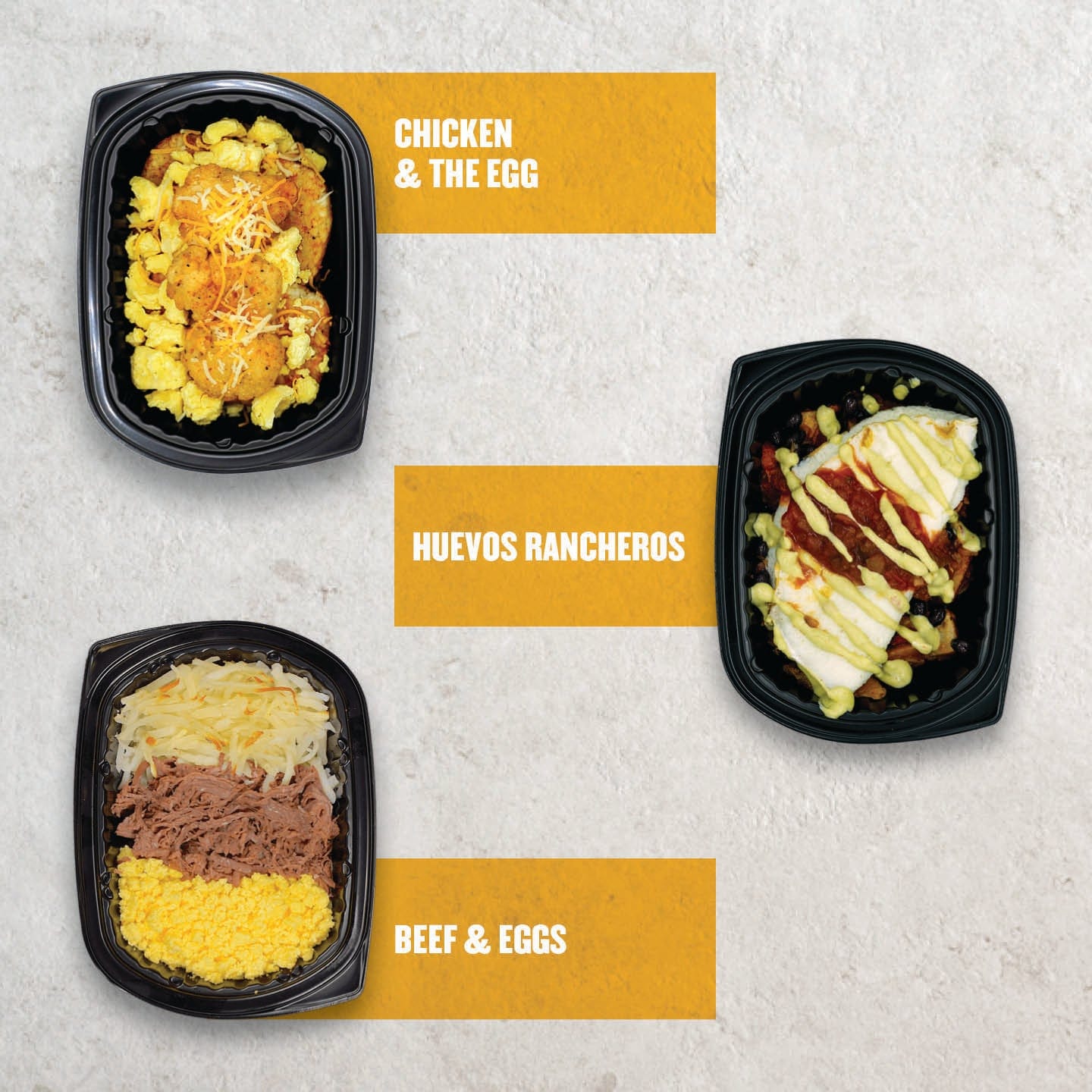 Clean Eatz Kitchen breakfast box meals including Chicken & the Egg, Huevos Rancheros, and Beef & Eggs shown in black microwaveable containers on a light background.
