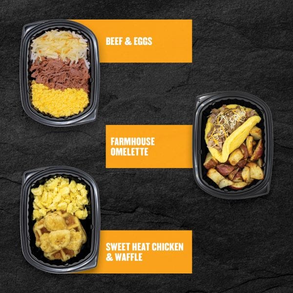 Clean Eatz Kitchen breakfast meals — Beef & Eggs, Farmhouse Omelette, and Sweet Heat Chicken & Waffle shown in black meal containers on a dark stone background with orange labels for each item.