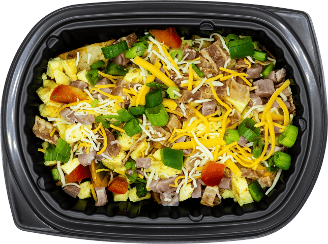 Prepared dish with eggs, cheese, vegetables, and meat in a black container.
