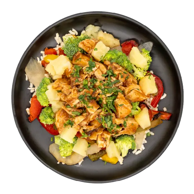 Jamaican jerk chicken with rice, broccoli, pineapple, and peppers on a black plate.