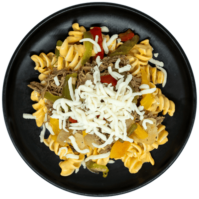 Shredded steak with peppers, onions, and mozzarella cheese over creamy mac and cheese on a black plate.