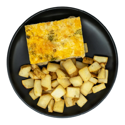 Cheesy egg quiche with broccoli and vegetables, served with roasted potatoes on a black plate.