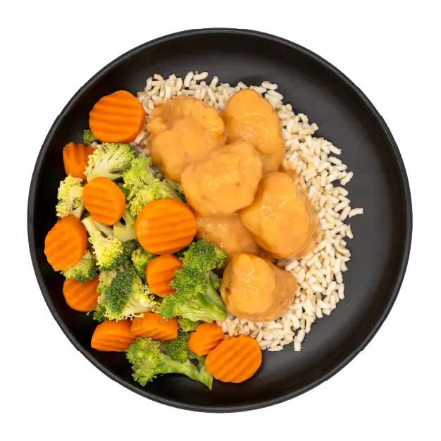 Tempura hibachi chicken with broccoli, carrots, and brown rice on a black plate.