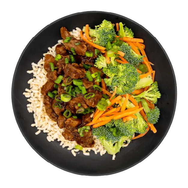 Teriyaki beef with broccoli, carrots, green onions, and brown rice on a black plate.