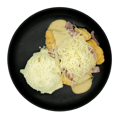 Breaded chicken with ham, shredded cheese, creamy sauce, and mashed potatoes on a black plate.