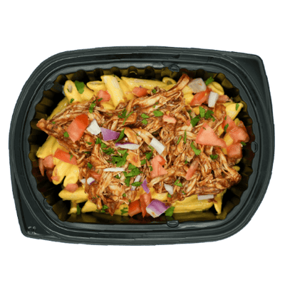 Shredded BBQ chicken over mac and cheese topped with diced tomatoes, red onions, and herbs in a black meal tray.