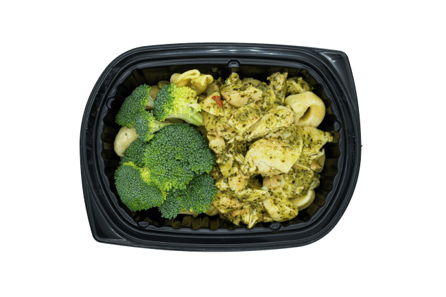Creamy pesto tortellini with chicken and broccoli in a black meal tray.