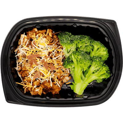 Monterey-style chicken topped with shredded cheese and bacon bits, served with broccoli in a black meal tray.