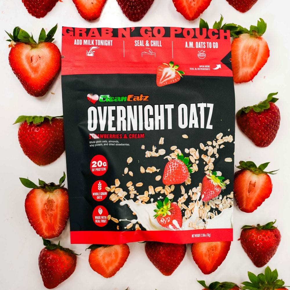 Clean Eatz Overnight Oatz Strawberries & Cream flavor pouch surrounded by fresh strawberries – high protein overnight oats made with real fruit