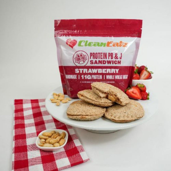 Clean Eatz Kitchen Protein Peanut Butter & Jelly 4-pack on a stand displaying a sandwich
