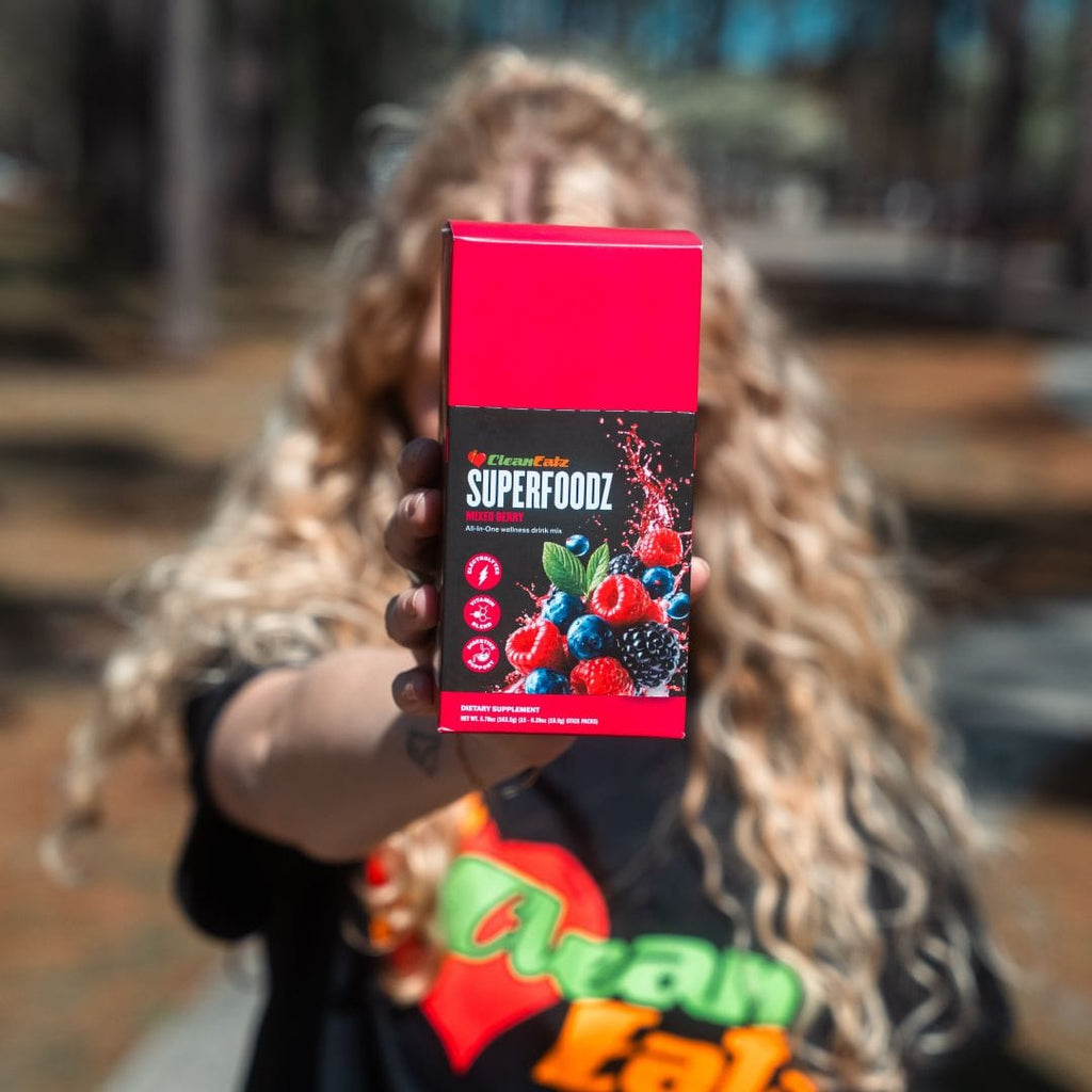 Person holding a Clean Eatz Superfoodz product package outdoors